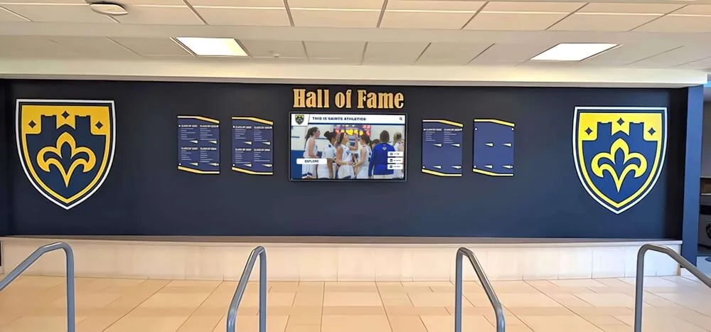 Hall of fame display wall with shields and screen