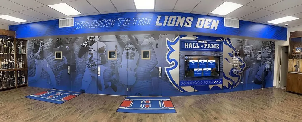 School Lions Den hall of fame mural with trophy cases displaying student achievement records School Lions Den hall of fame mural and trophy cases for student recognition