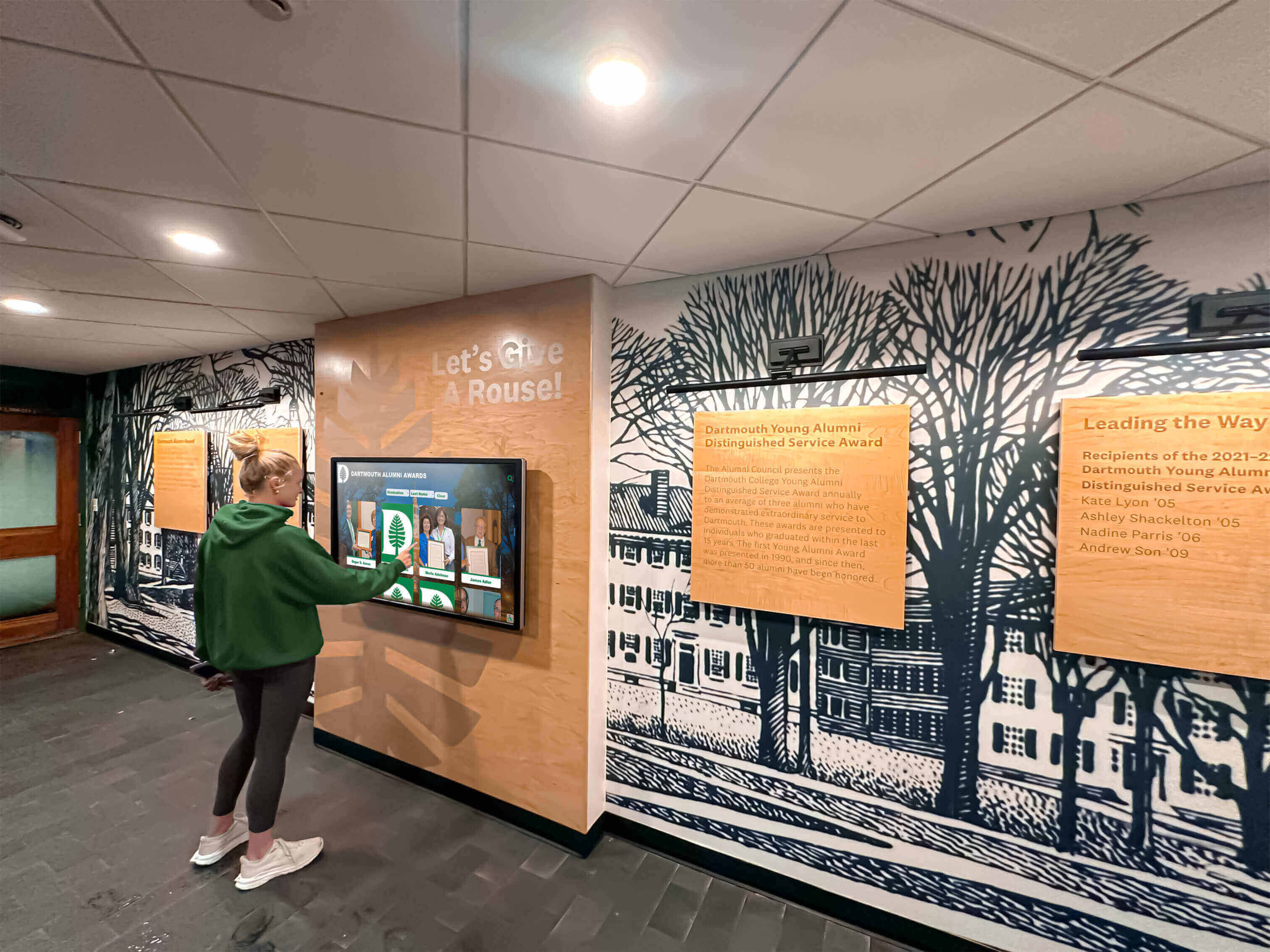 Student using touchscreen display in hallway