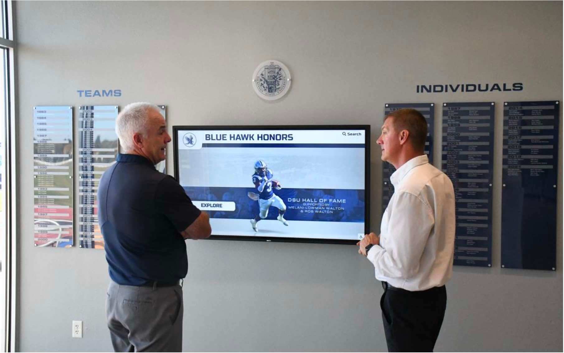 Students viewing digital recognition wall