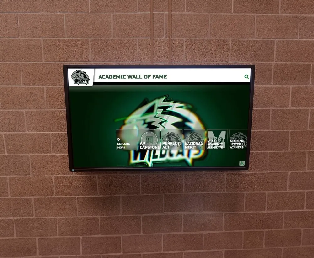 Wildcats academic wall of fame with digital screen on brick wall